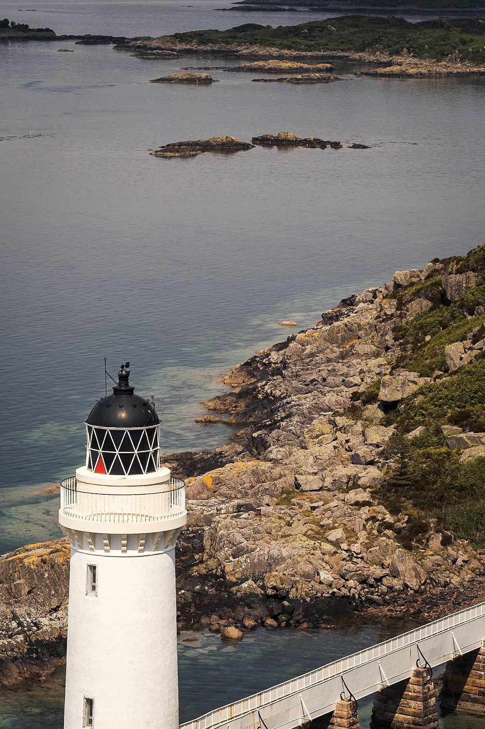 Looking down on Kyleakin lighthouse, its walkway and the rocky shore