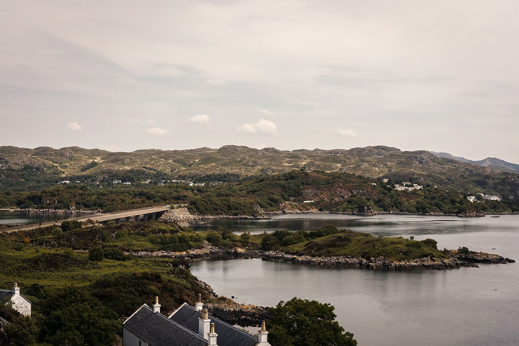 Looking over rooftops to a sea loch dotted with islands near Kyle of Lochalsh